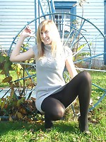 Young amateur girl in pantyhose posing in public place